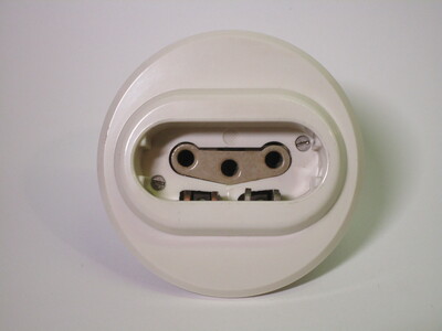 Front of the socket. It has an indentation with three holes for the phases and two side contacts for the earth and neutral.
