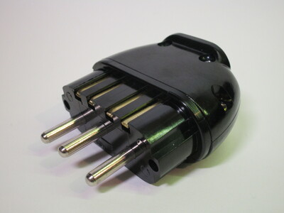 Front of the plug. It's made of a brown hard plastic-like material.