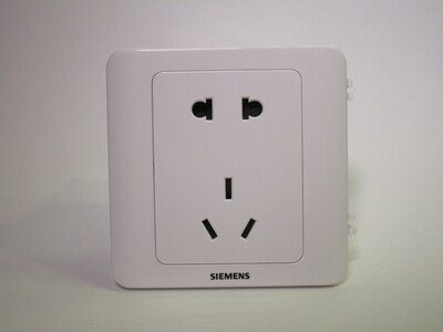 Front of the socket. It's made of white glossy plastic.