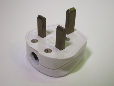 Front view of the plug. It's made of white plastic. The pins aren't sleeved.