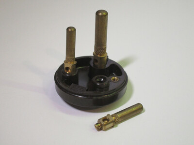 Internals of the plug with one of the pins taken off to show the terminals.